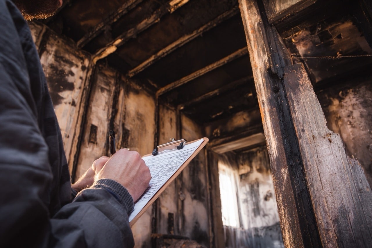Professional assessing fire damage on Ohio residential property